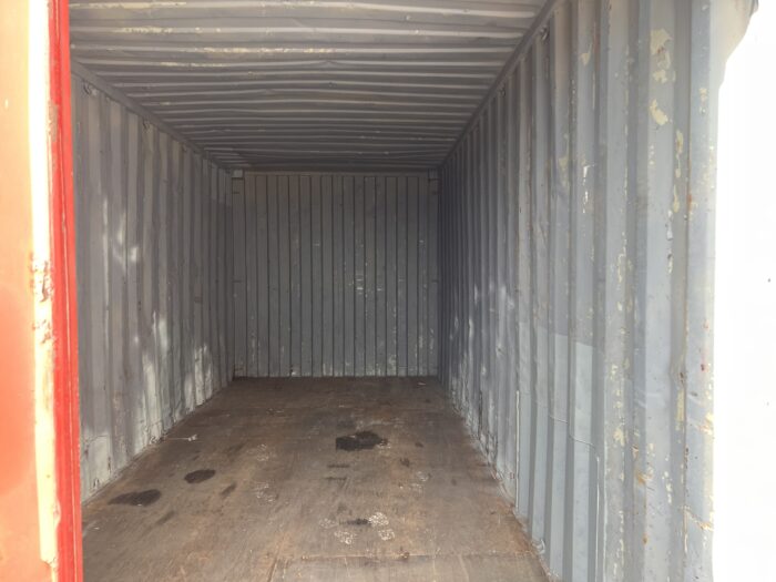 Inside view of a 20ft used shipping container showing wooden floor and corrugated steel walls