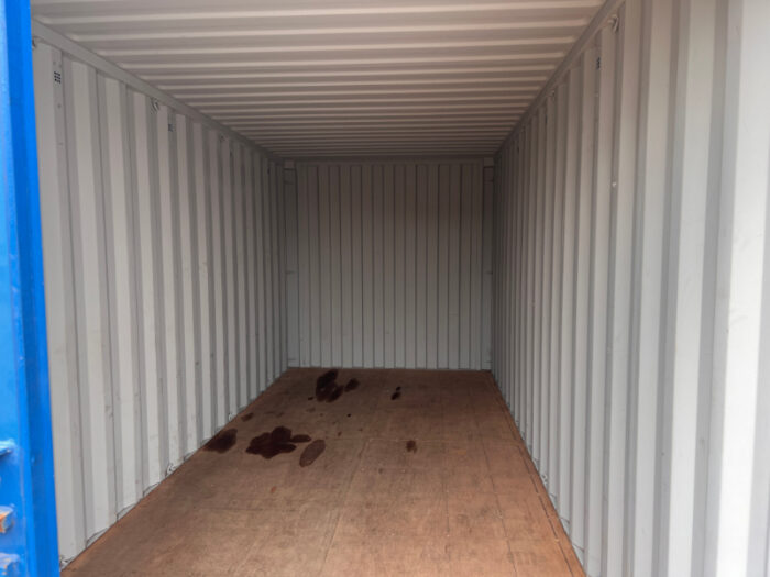Interior of a 20ft ex-hire shipping container with clean walls and plywood floor