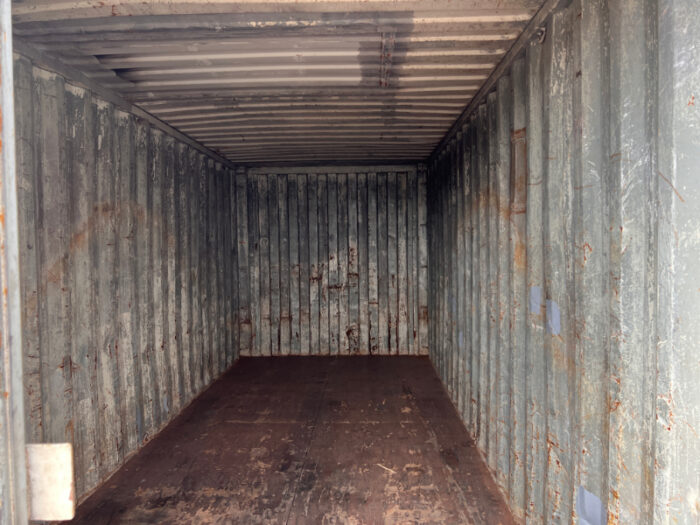Inside of a 20ft used container with wooden flooring and steel panel walls