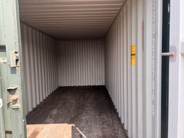 Interior of a 20ft shipping container with walls and wooden floor