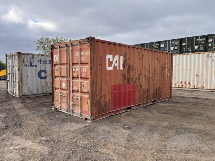 Side and front view of a used 20ft WWT shipping container with CAI branding