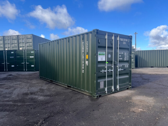 New 20ft green Parsons Containers steel unit in open yard with blue sky.