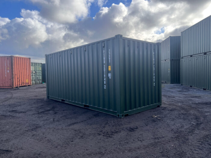 Green one-trip 20ft steel container in open yard with cloudy sky, ideal for dry storage and logistics.