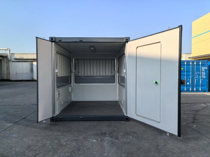 interior of 10ft container kiosk with serving hatches and personnel door, clean insulated steel unit